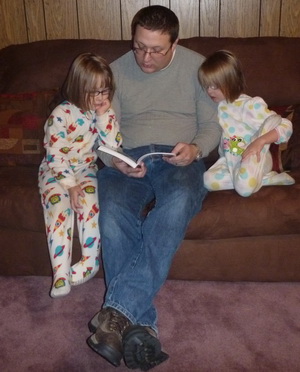 Daddy reading about "goats" to the girls (love Karlie's intent look and Brina who is twisting her leg in what looks like a very uncomfortable position)